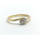 An 18ct gold two stone diamond ring, approx .13ct,