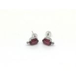 A boxed pair of 18ct white gold ruby and diamond s