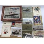 A collection of vintage Cunard cruising items including a jigsaw of the 'Queen Elizabeth', postcards