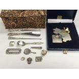 A collection of silver items comprising brooches,