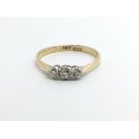 An 18ct gold three stone diamond ring, approx .20c