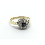 An 18carat gold ring set with a sapphire flanked b
