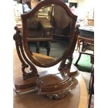 A Victorian walnut dressing mirror the shaped mirr