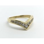 An 18carat gold ring of wishbone shape set with br