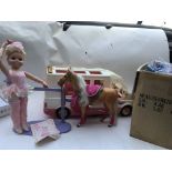 A box containing a Barbie caravan/ Motorhome, a Ba