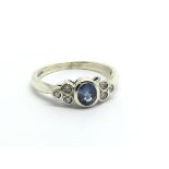 A 9ct white gold six stone diamond and sapphire ri