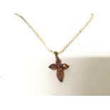 A 9carat gold necklace with an amber cross pendent