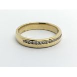 An 18carat gold ring set with a row of diamonds. R