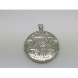 A large silver locket pendant inscribed with a Sta