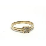 A 9ct gold ring set with four small diamonds, appr
