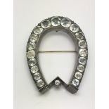 A large Victorian silver and paste horseshoe brooc