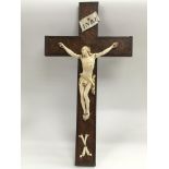 An antique ivory and burr maple Christ on the cros