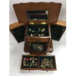A jewellery cabinet in the form of a chest of draw