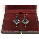 A boxed pair of flared design drop earrings set wi