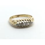 A vintage 18ct gold ring set with five small diamo