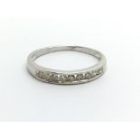 An 18ct white gold half eternity diamond ring, app