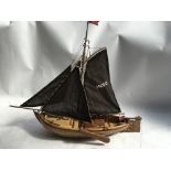 A wooden model boat , with slatted hull, hand buil