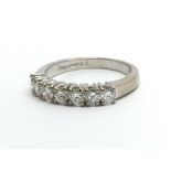 An 18ct white gold seven stone half eternity ring,