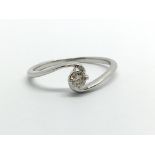 A 9ct white gold solitaire diamond ring, approx .1