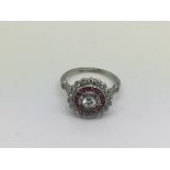 An Edwardian style platinum, ruby and diamond clus