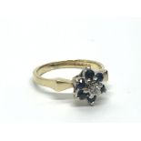 An 18ct gold ring set with a central diamond surro