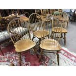 A set of six beechwood Windsor style chairs with turned legs and a conforming extending dining