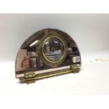 A 1930s peach mirrored brass mounted electric cloc