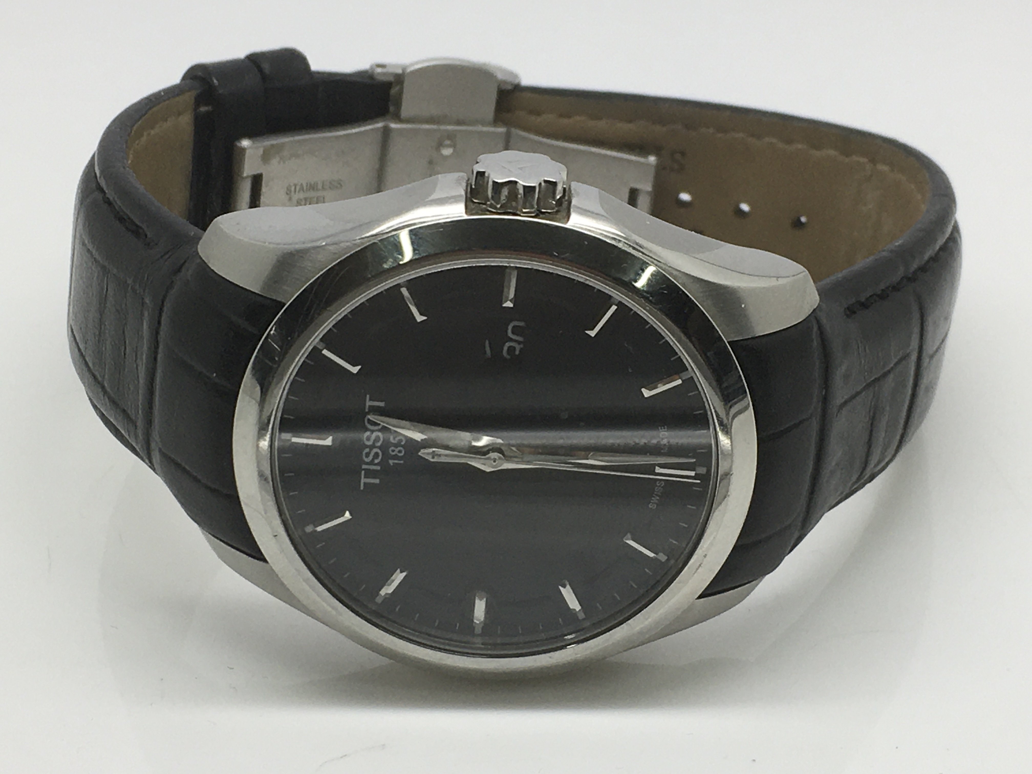 A gents Tissot watch with a black face and silvere