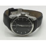 A gents Tissot watch with a black face and silvere