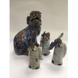 A glazed terracotta Fo dog and three figures of el