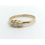 A vintage 18ct gold three stone diamond ring, appr