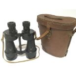 A pair of Military binoculars in a leather case.