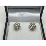 A boxed pair of 18ct white gold seven stone diamon