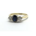 An 18ct gold ring set with a central sapphire and