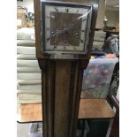 A walnut grand mother clock the square dial with R