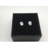 A boxed pair of silver studs set with white Ethiop