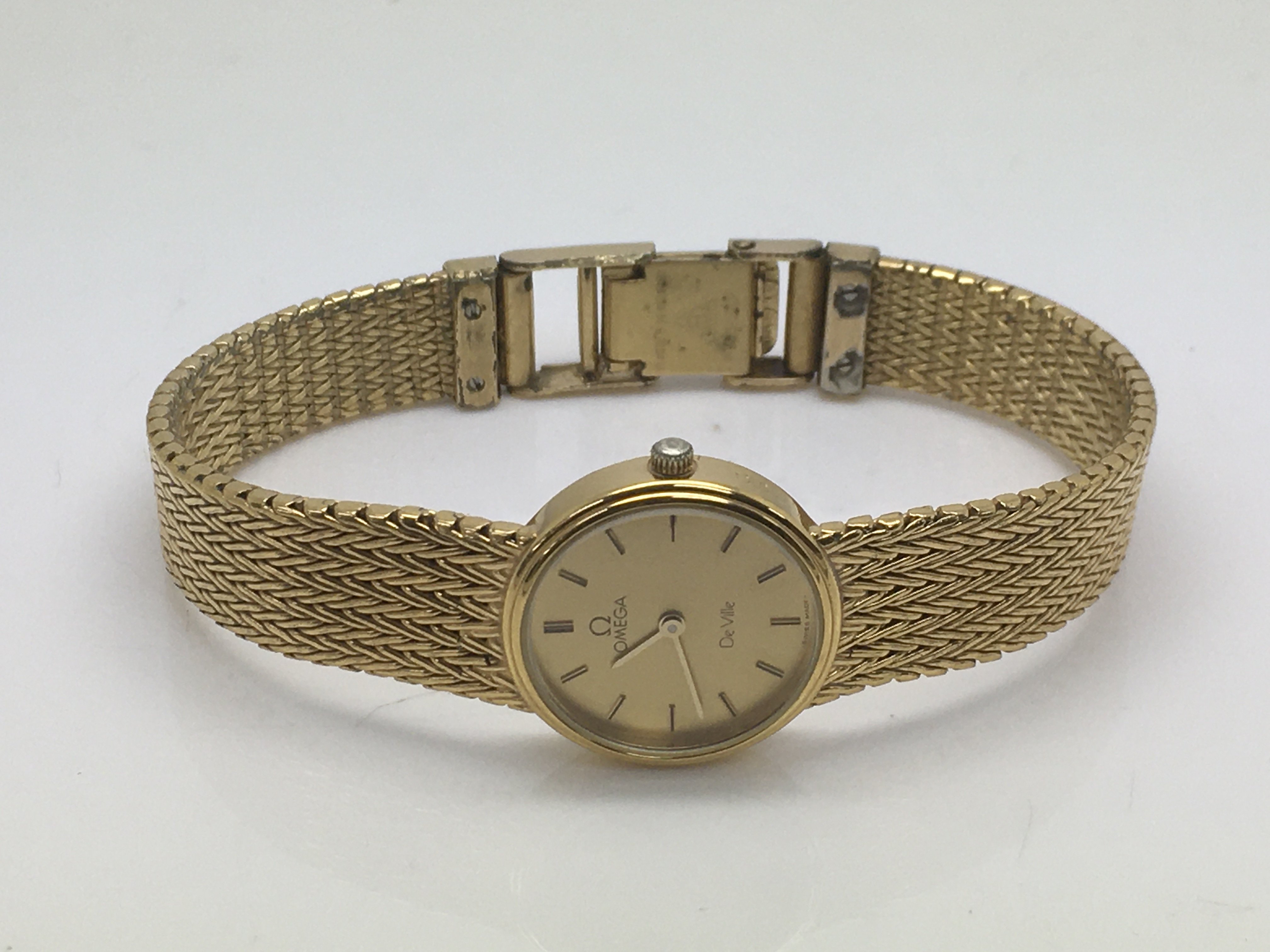 A ladies gold tone Omega Deville watch.