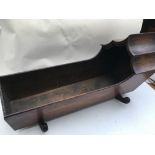 A late Victorian Wooden dolls crib with shaped hoo