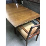 A 1970s teak table with six chairs including two c