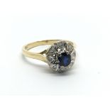 An 18carat gold ring set with a sapphire flanked b