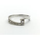 A 9ct white gold solitaire diamond ring with furth