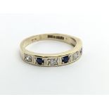 A 9ct gold half eternity ring set with alternating