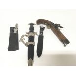 A collection of retrospective military items a Hitler Youth Knife presentation German Dagon flint