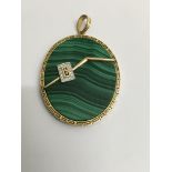 A oval malachite pendant surrounded with a 14 k gold mount .5 cm