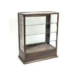 A small mahogany table top glazed shop display cabinet the glazed door giving access to three
