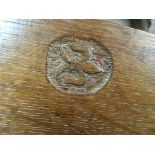 A small 1920s oak Sutherland table having arts and crafts influences with carved fleur de lis