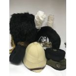 A collection of retrospective Military hats French legion style a bearskin pith helmet and an