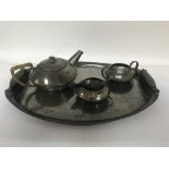 A Liberty's Archibald Knox design Tudric tea set with aesthetic influences comprising tea pot milk