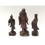 Three carved wood Japanese figures with porcelain eyes, largest approx 27cm tall