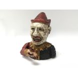 An antique American money bank in the form of a clown